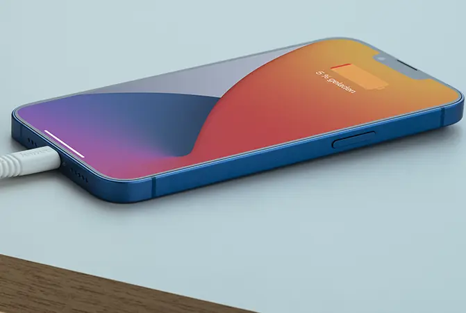 Um iPhone carrega lentamente enquanto está pousado na mesa.