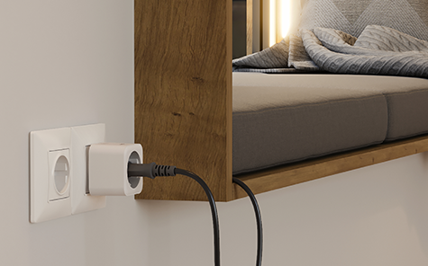 Smart Hama socket charges a mobile device.